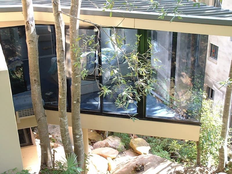A Building With A Lot Of Windows Surrounded By Trees — South Coast Glass In South Nowra, NSW