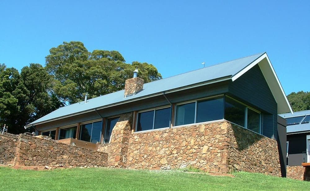 A House With A Lot Of Windows And A Chimney On The Roof — South Coast Glass In South Nowra, NSW