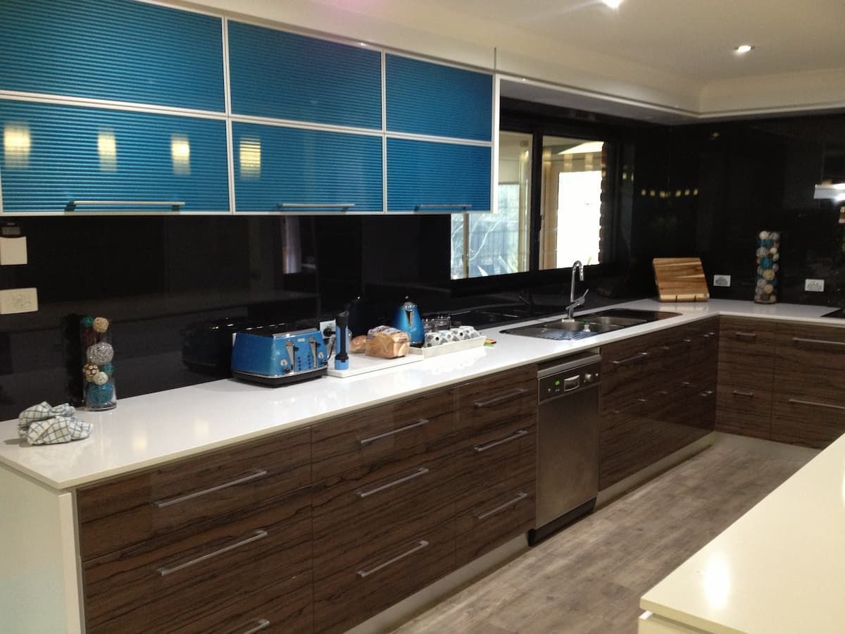 A Kitchen With Blue Cabinets And White Counter Tops — South Coast Glass In South Nowra, NSW