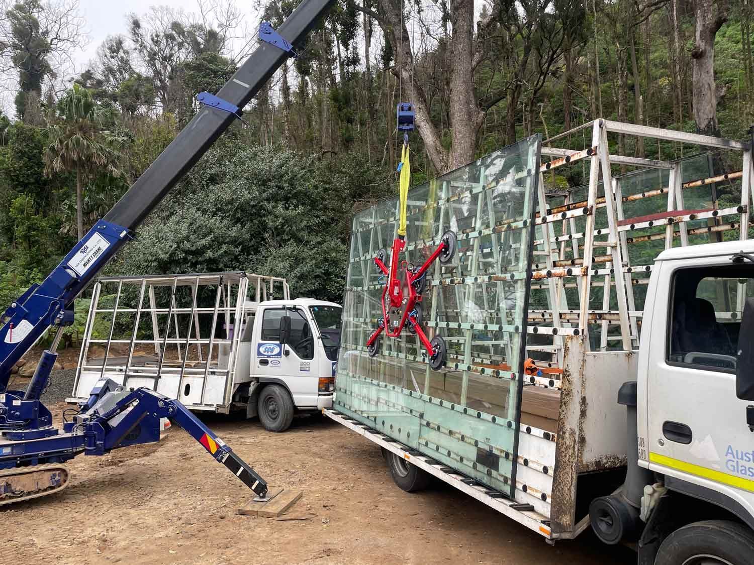 A Crane Holding Large Piece Glass — South Coast Glass In South Nowra, NSW