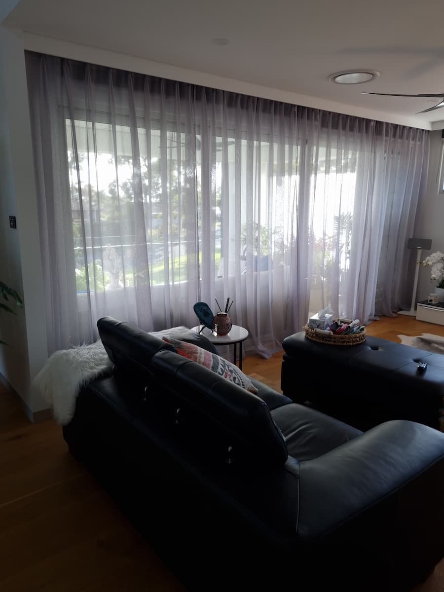 A Living Room With A Couch , Table , And Curtains — South Coast Glass In South Nowra, NSW