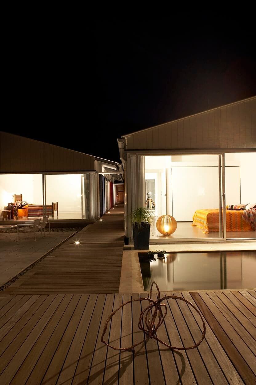 A House With A Swimming Pool And A Wooden Deck At Night — South Coast Glass In South Nowra, NSW