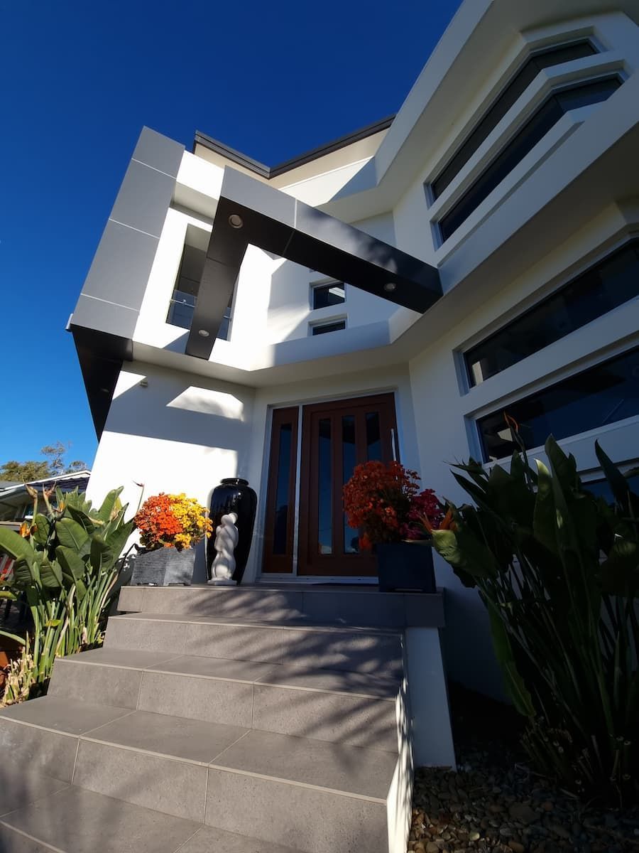 A White House With Stairs Leading Up To The Front Door — South Coast Glass In South Nowra, NSW