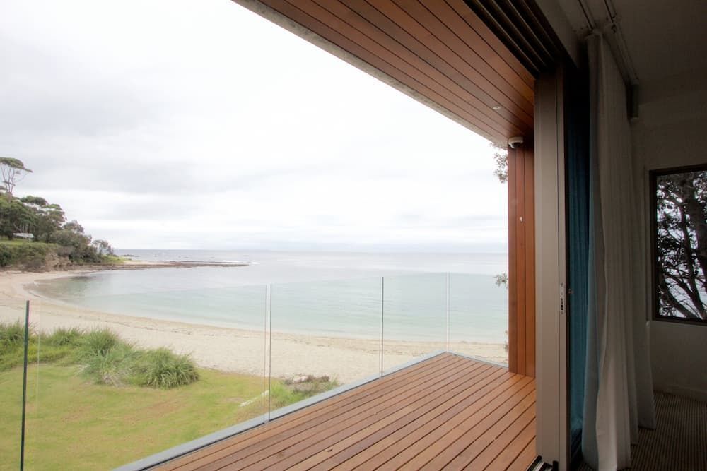 A View Of The Ocean From A Balcony With A Glass Railing — South Coast Glass In South Nowra, NSW