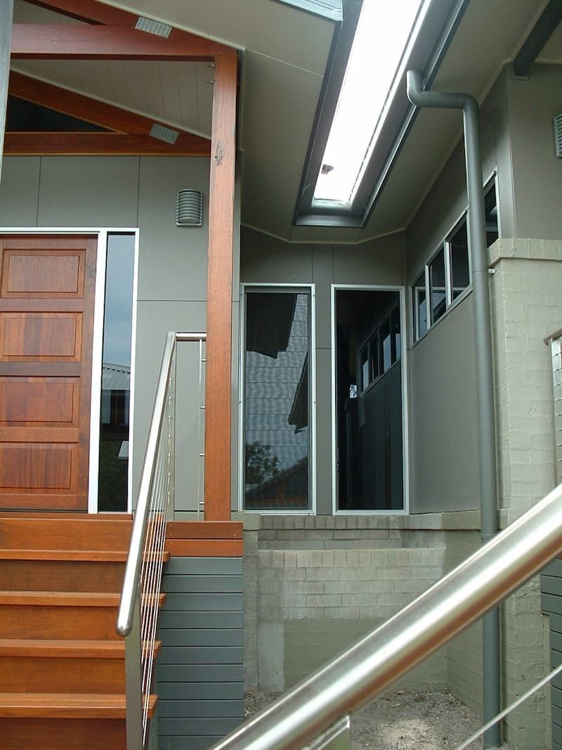 A House With Stairs Leading Up To The Front Door — South Coast Glass In South Nowra, NSW