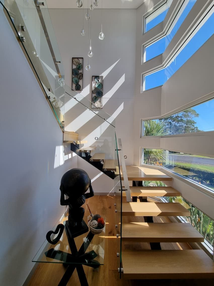 A Staircase With A Glass Railing And A Globe On A Table — South Coast Glass In South Nowra, NSW