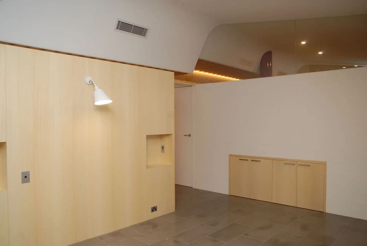 An Empty Room With A White Wall And Wooden Cabinets — South Coast Glass In South Nowra, NSW