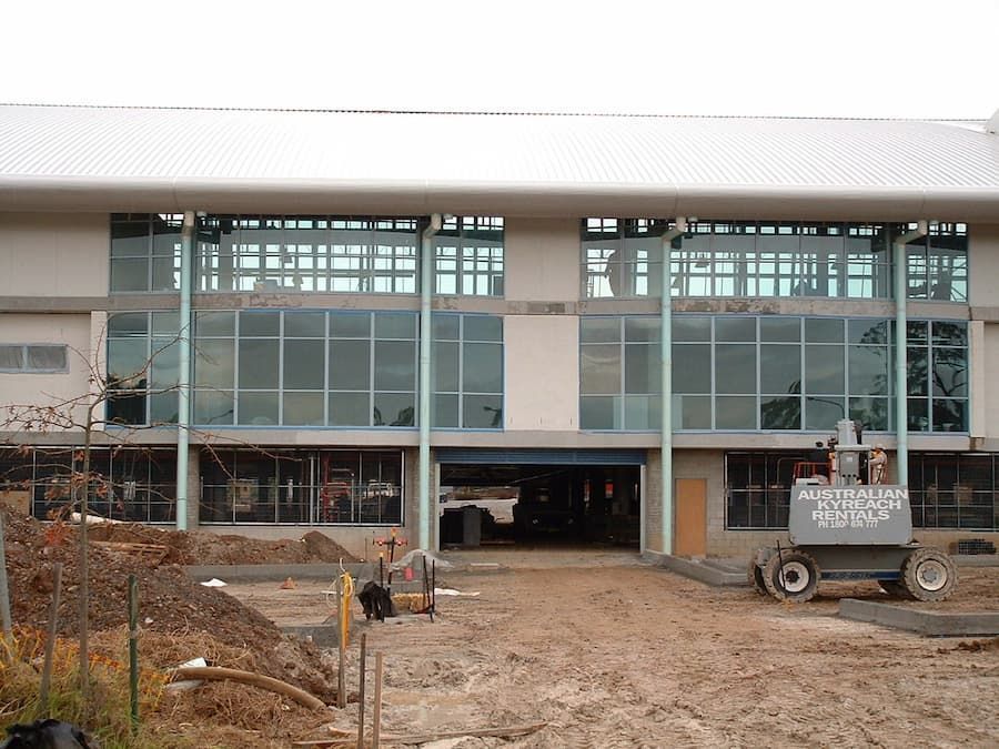 A Large Building With A Lot Of Windows Is Being Built — South Coast Glass In South Nowra, NSW