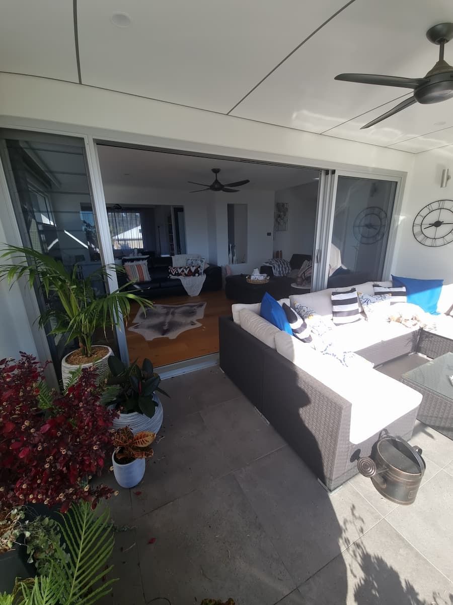 A Living Room With A Lot Of Furniture And A Ceiling Fan — South Coast Glass In South Nowra, NSW