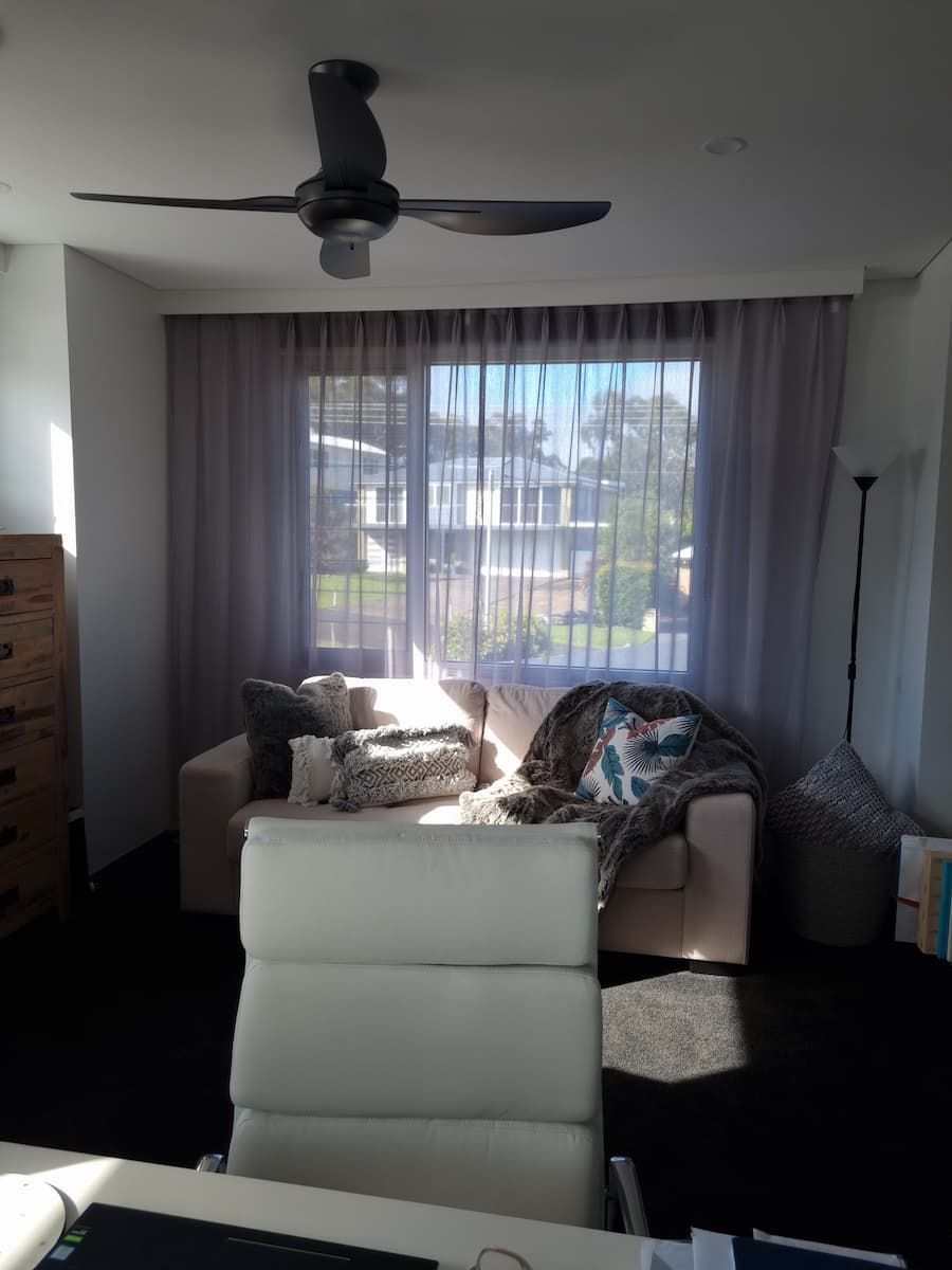 A Living Room With A Ceiling Fan And A Couch — South Coast Glass In South Nowra, NSW
