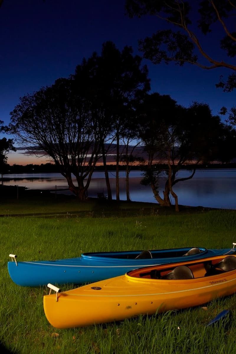 Two Kayaks Are Sitting On The Grass Near A Lake At Night — South Coast Glass In South Nowra, NSW