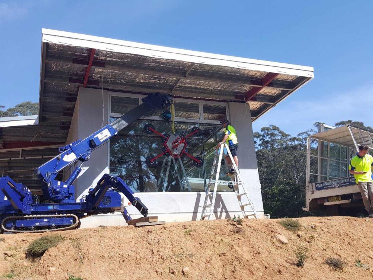 A Crane Truck Installing Glass Windows — South Coast Glass In South Nowra, NSW