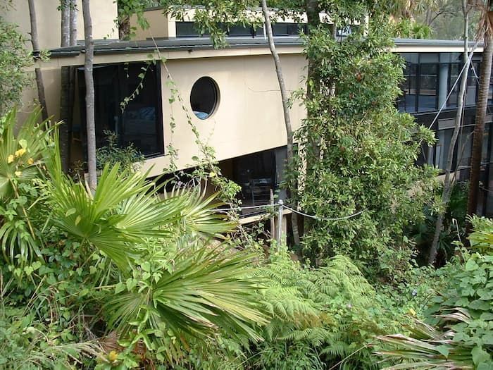 A House With A Round Window Is Surrounded By Trees — South Coast Glass In South Nowra, NSW