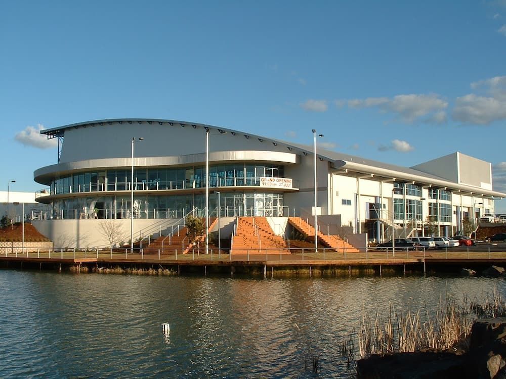 A Large Building Sits Next To A Body Of Water — South Coast Glass In South Nowra, NSW