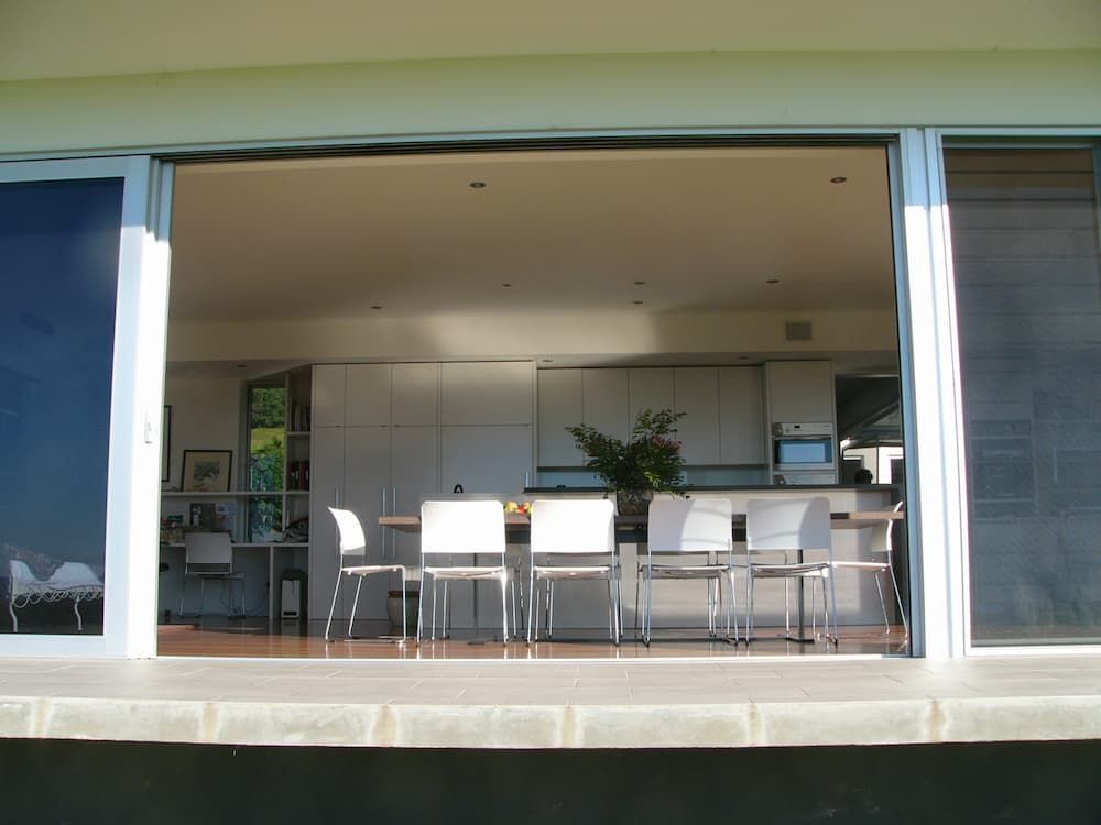 A View Of A Kitchen And Dining Room Through A Sliding Glass Door — South Coast Glass In South Nowra, NSW