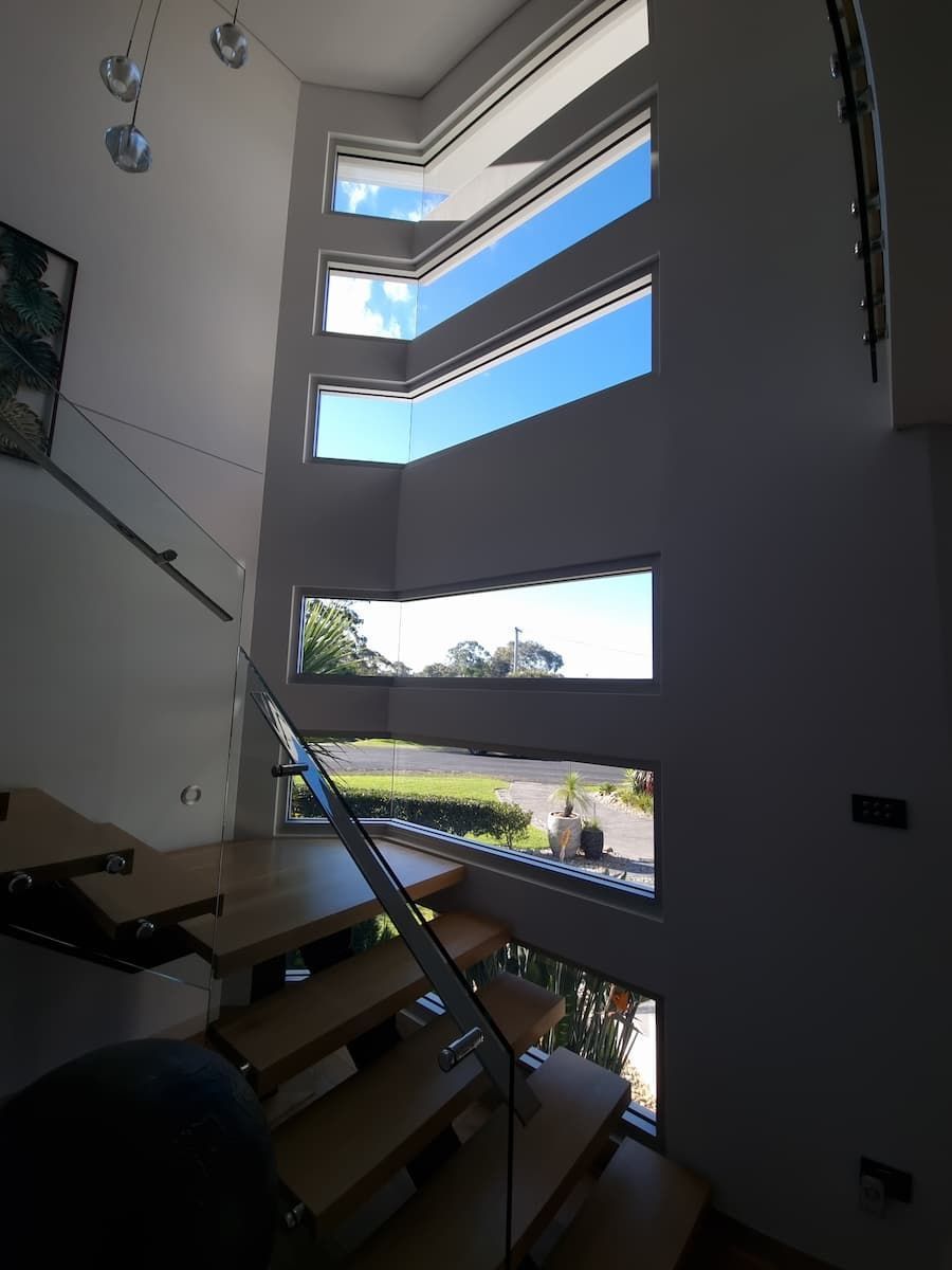 A Staircase With Lots Of Windows And A Blue Sky In The Background — South Coast Glass In South Nowra, NSW