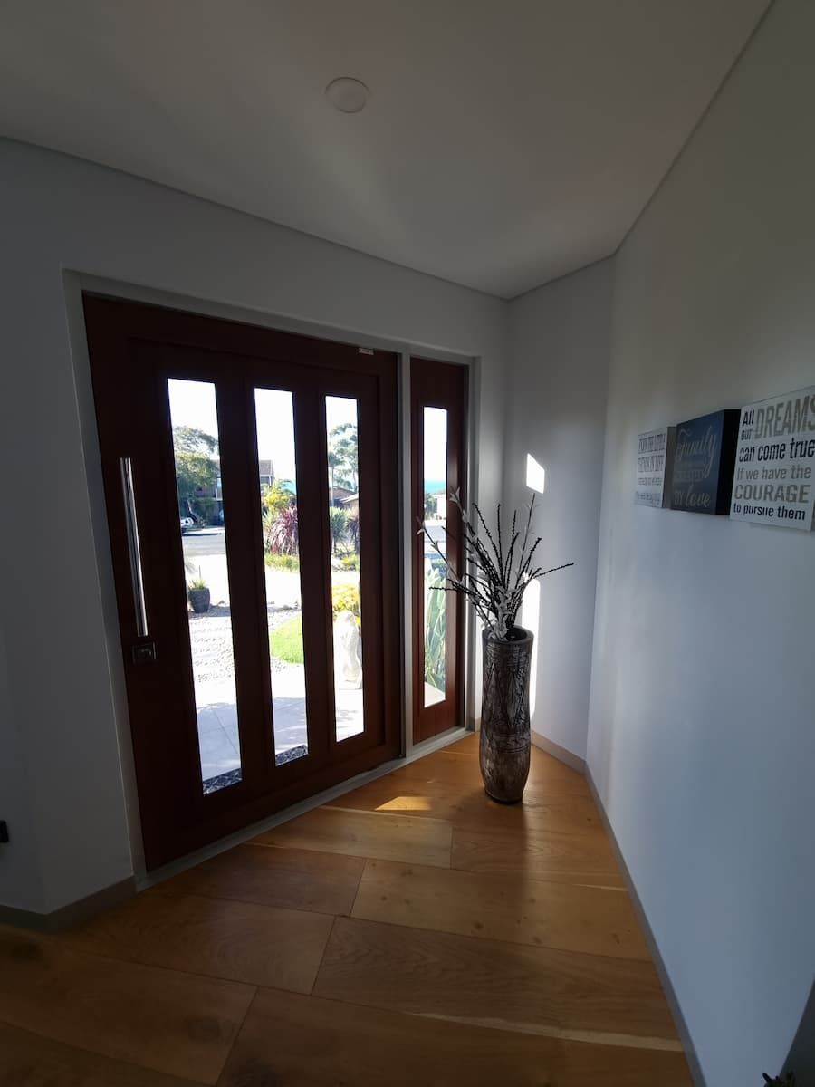 A Hallway With A Vase Of Flowers In The Corner — South Coast Glass In South Nowra, NSW