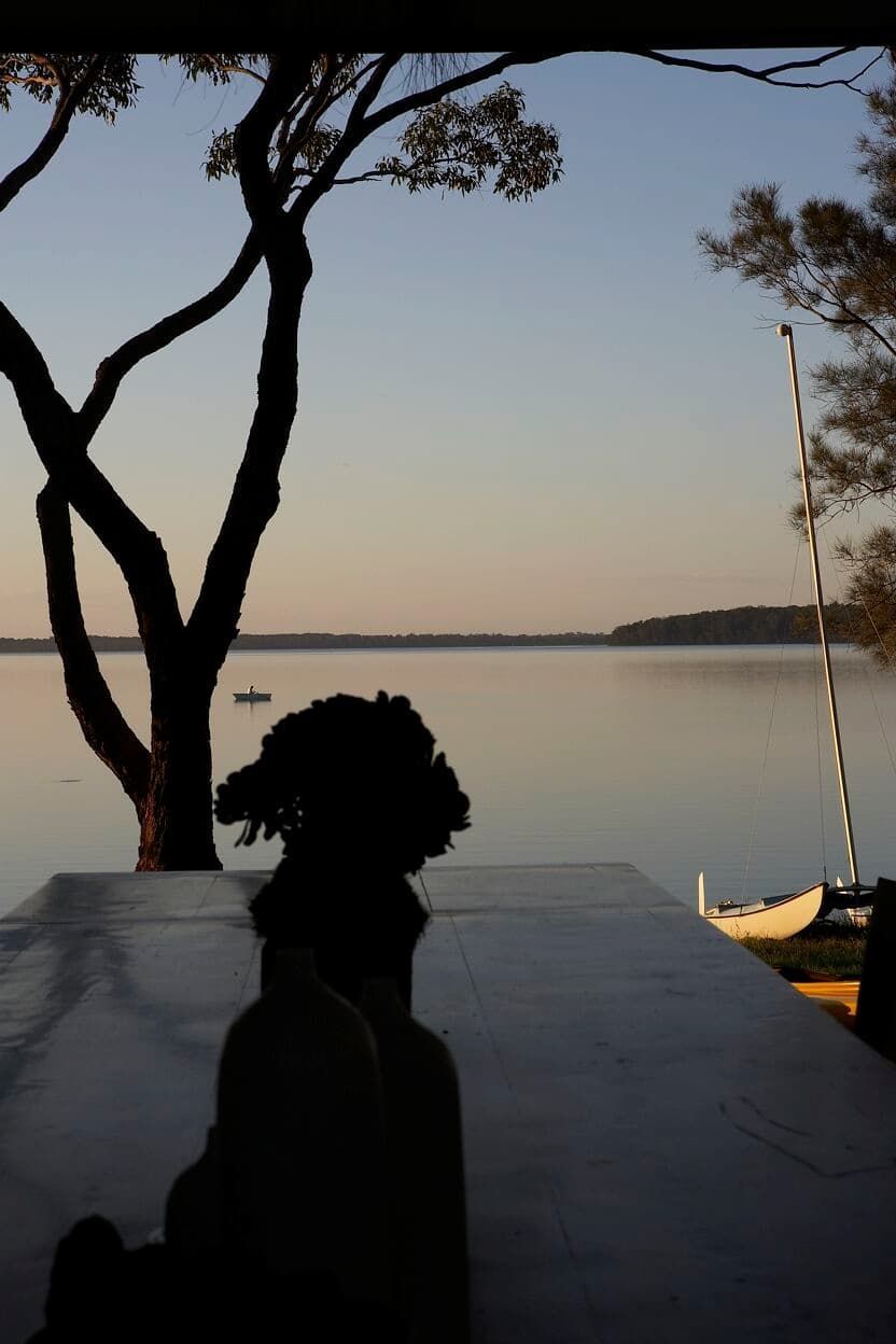 A Silhouette Of A Person Looking Out Over A Body Of Water — South Coast Glass In South Nowra, NSW