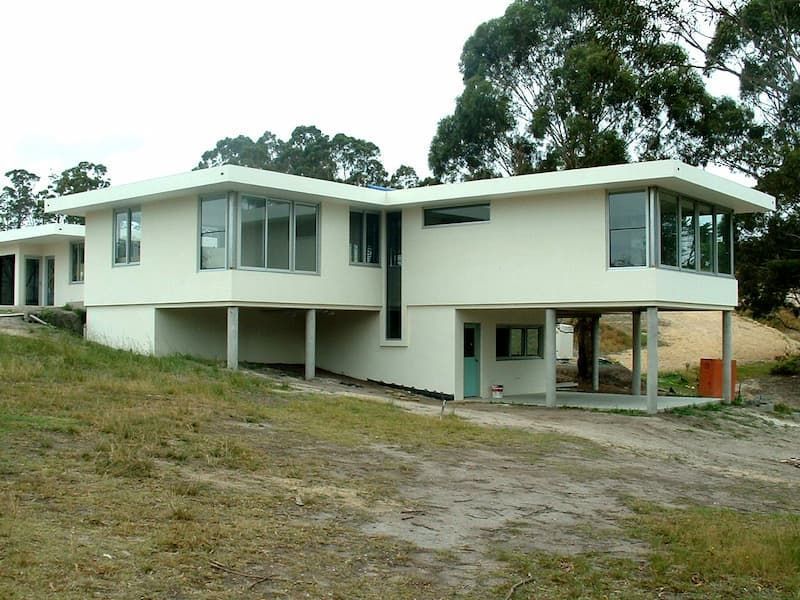 A White House With A Lot Of Windows And Trees In The Background — South Coast Glass In South Nowra, NSW