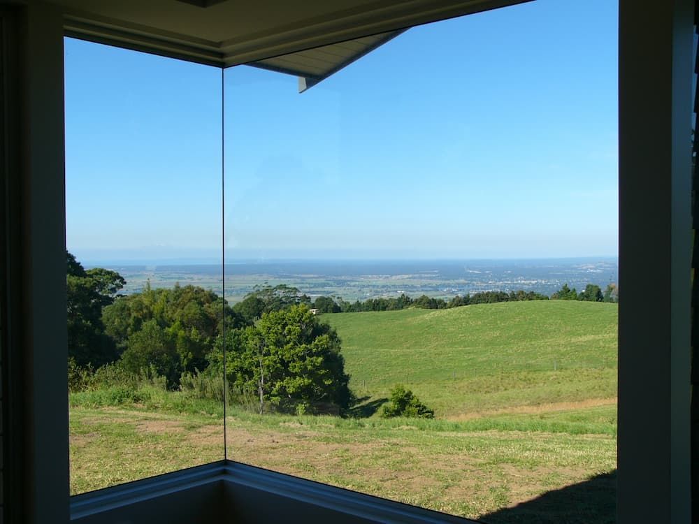 A View Of A Lush Green Field Through A Window — South Coast Glass In South Nowra, NSW