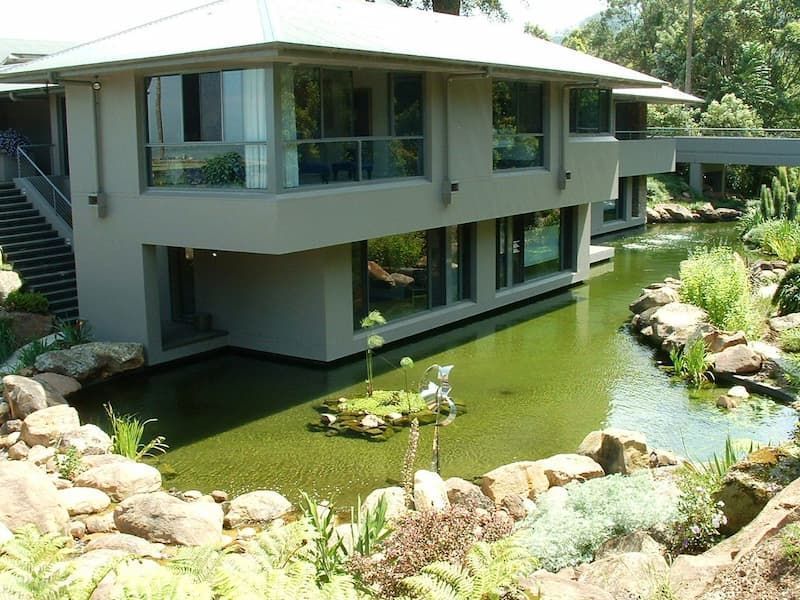 A Large House With A Pond In Front Of It — South Coast Glass In South Nowra, NSW