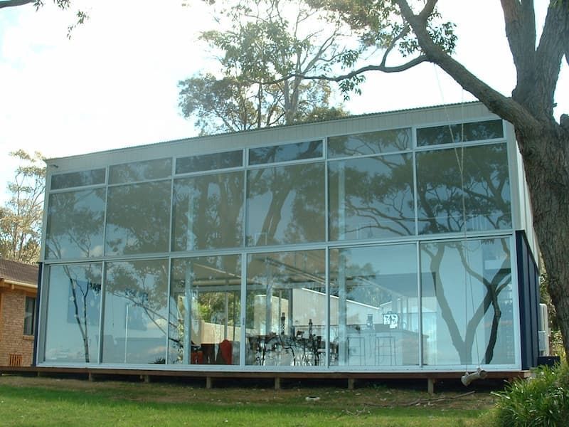 A House With A Lot Of Windows And A Tree In Front Of It — South Coast Glass In South Nowra, NSW