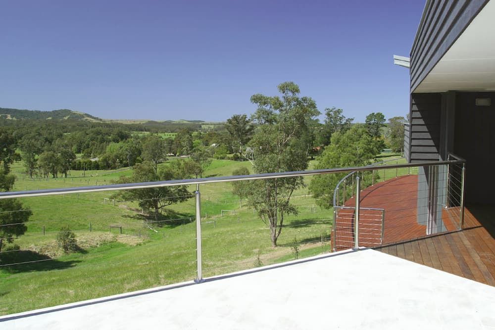 A Balcony With A View Of A Field And Trees — South Coast Glass In South Nowra, NSW
