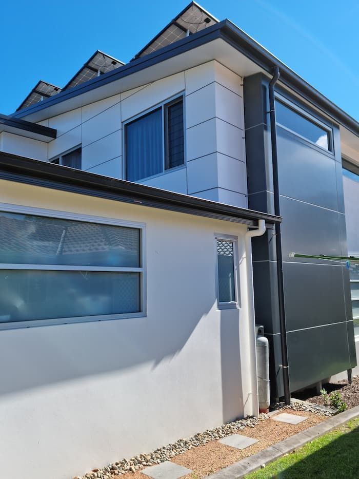 A White House With A Lot Of Windows And Solar Panels On The Roof — South Coast Glass In South Nowra, NSW