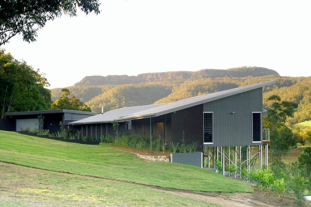 A House On A Hill With Mountains In The Background — South Coast Glass In South Nowra, NSW