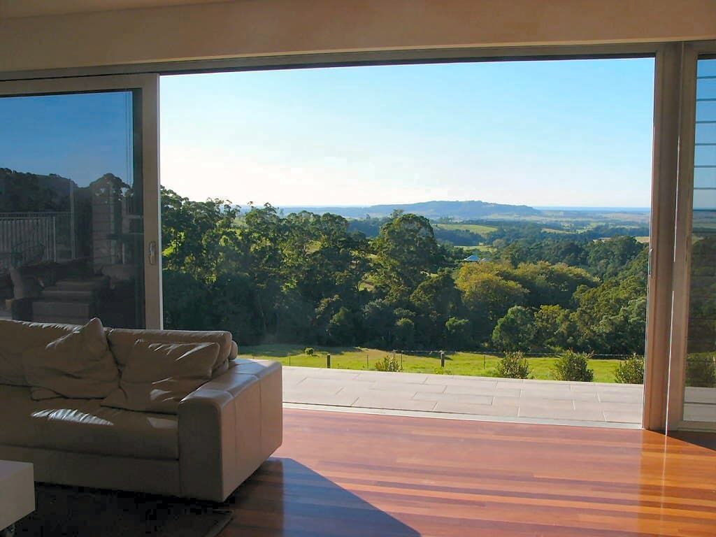 A Living Room With A Couch And A View Of Trees — South Coast Glass In South Nowra, NSW