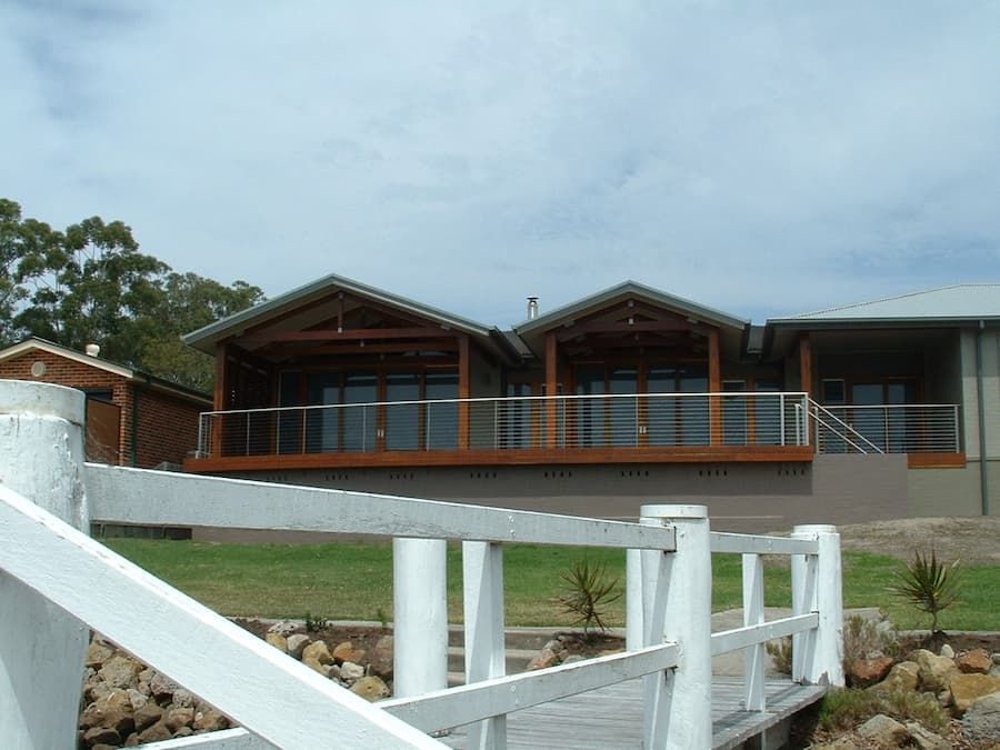 A House With A White Fence In Front Of It — South Coast Glass In South Nowra, NSW