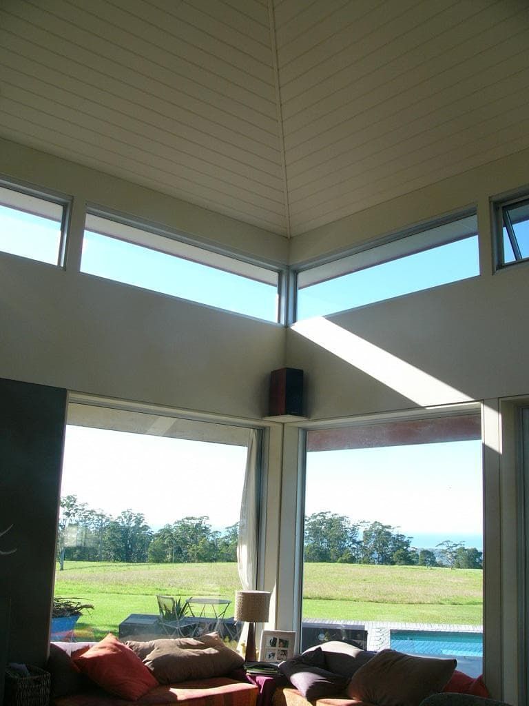 A Living Room With A View Of A Field And A Pool — South Coast Glass In South Nowra, NSW