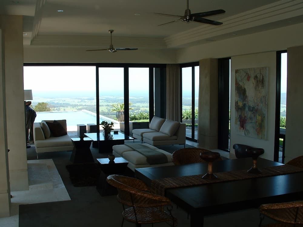 A Living Room With A Table And Chairs And A Ceiling Fan — South Coast Glass In South Nowra, NSW