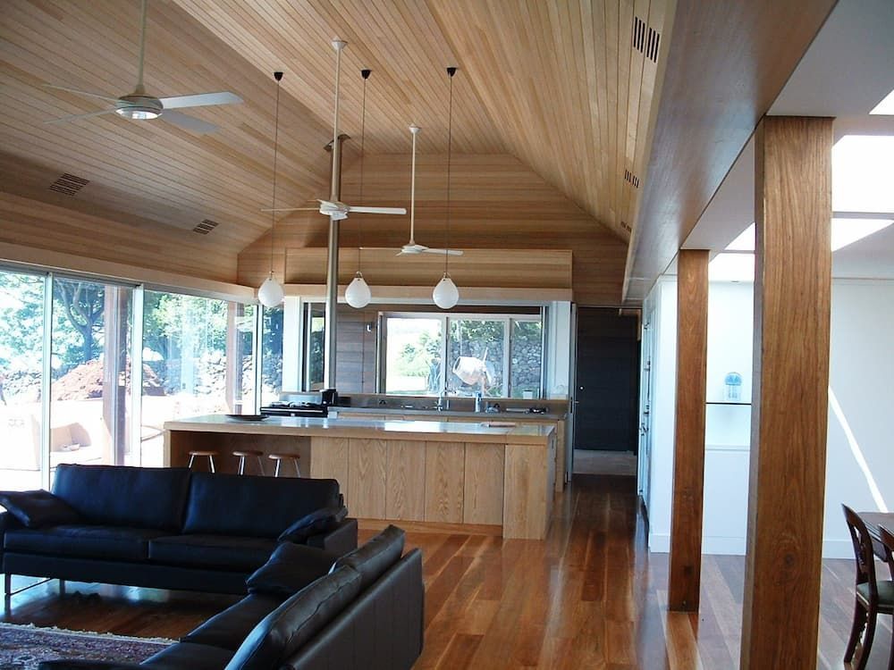 A Living Room With A Couch And A Kitchen In The Background — South Coast Glass In South Nowra, NSW