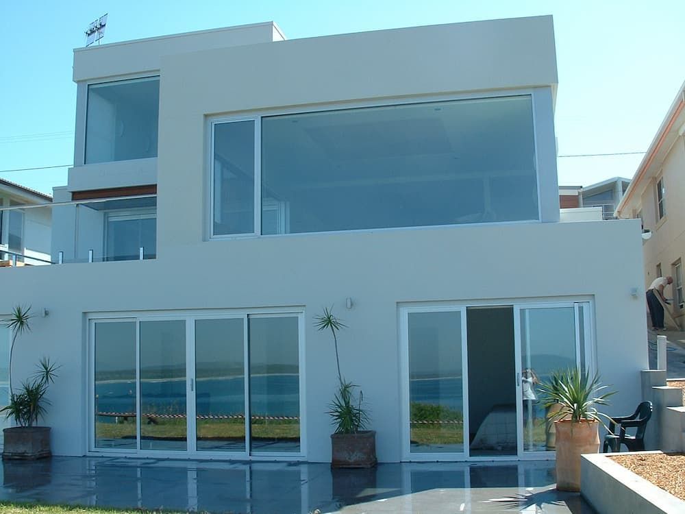 A Large White House With A Lot Of Windows — South Coast Glass In South Nowra, NSW
