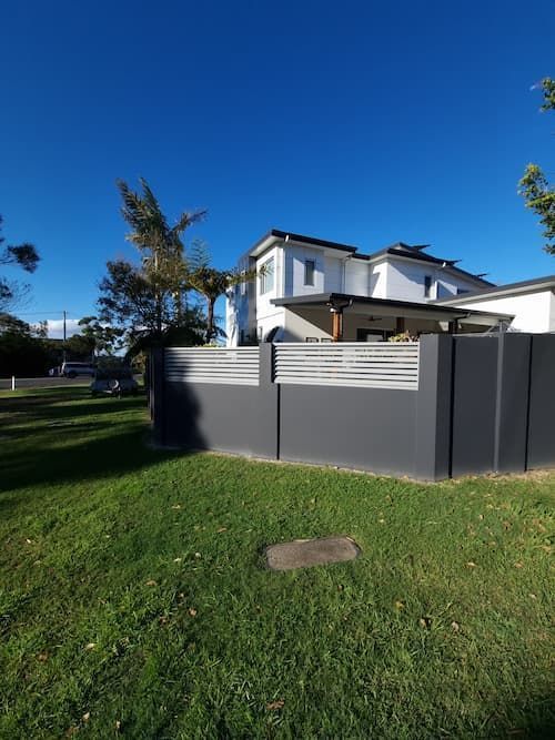 A White House With A Black Fence In Front Of It — South Coast Glass In South Nowra, NSW