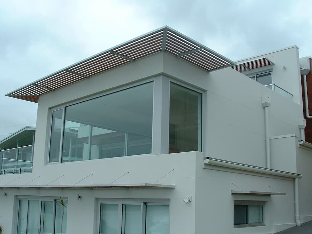 A White House With Lots Of Windows And A Wooden Roof — South Coast Glass In South Nowra, NSW