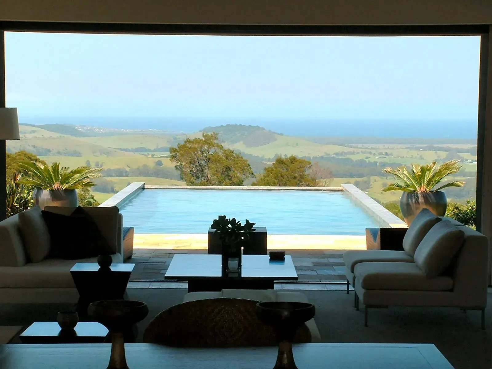 Living room with panoramic view of pool and rolling hills — South Coast Glass In South Nowra, NSW