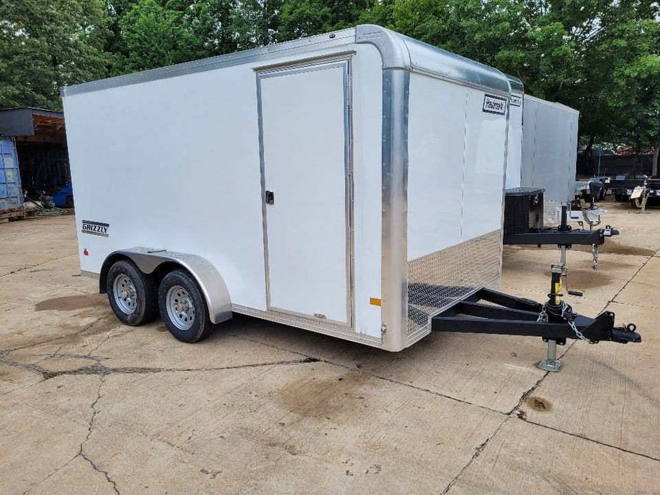 White enclosed cargo trailer, dual axles, door on side, parked outdoors. | Gainesville Garage & Trailer Sales
