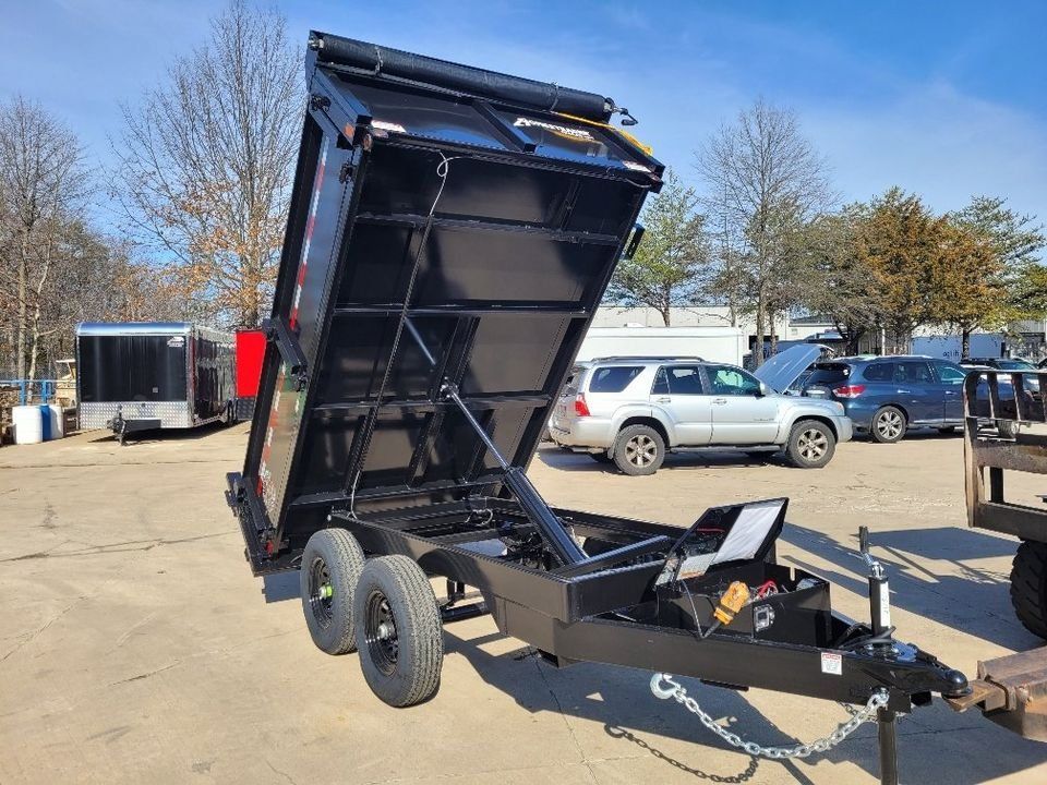 Black dump trailer with the bed raised on a sunny day. | Gainesville Garage & Trailer Sales