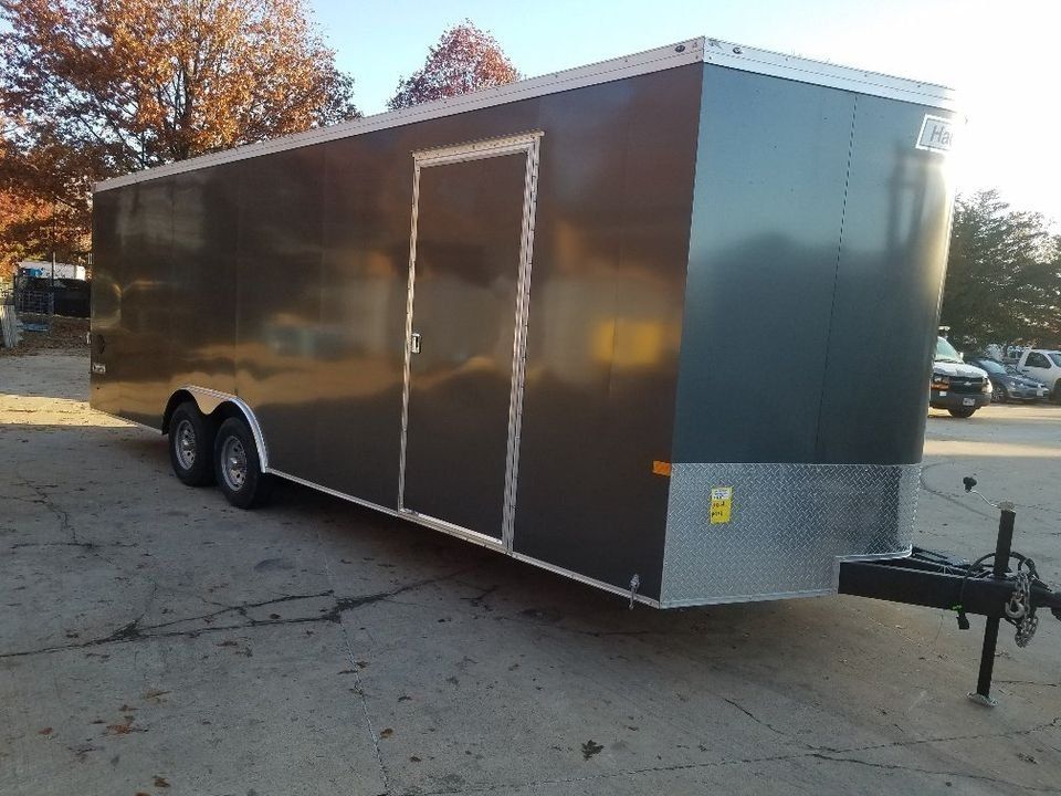 Dark gray enclosed trailer with door and silver front, parked outdoors. | Gainesville Garage & Trailer Sales
