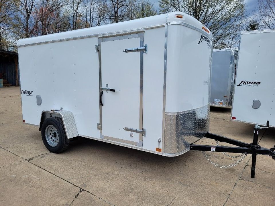 White enclosed cargo trailer with a black hitch on a paved surface. | Gainesville Garage & Trailer Sales