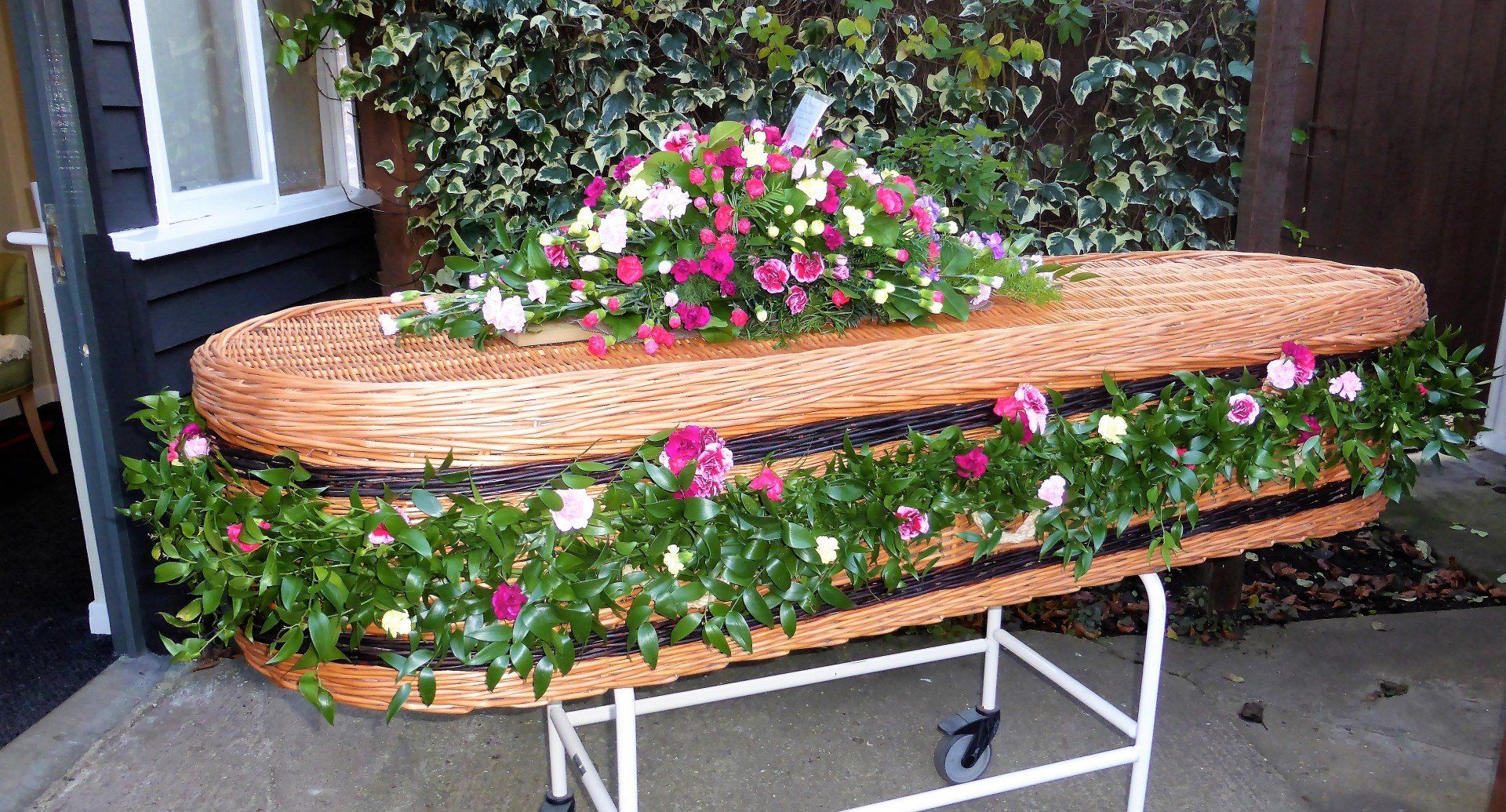 8.  Full Garland of Soft Ruscus decorated with wired pink Dianthus and posies