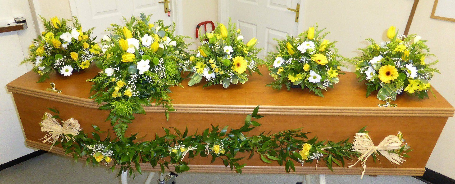 5.  Half Garland of Soft Ruscus decorated with yellow Rosebuds, Gypsophila and Raffia bows