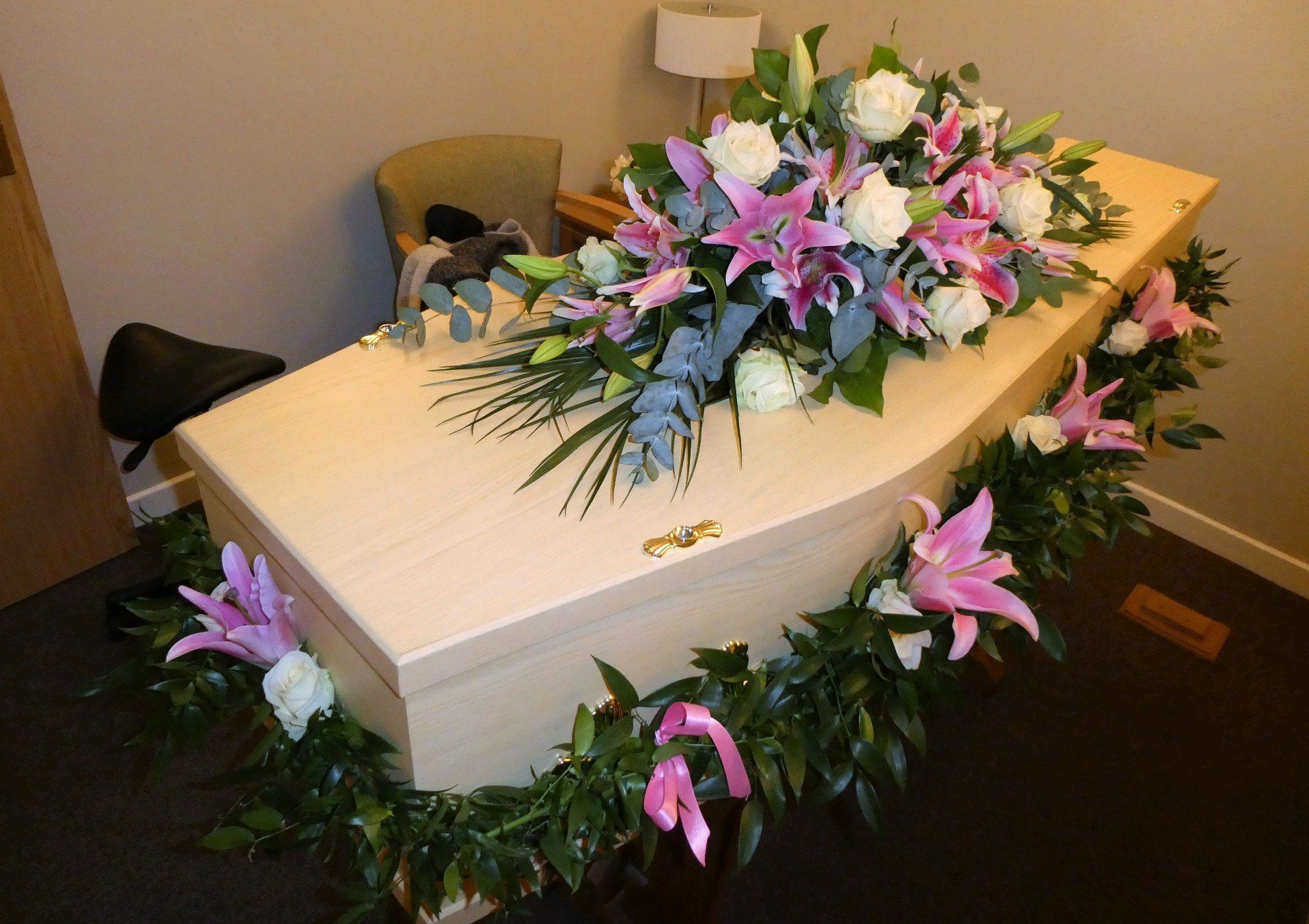 3.  Garland of Soft Ruscus with pink Lily’s, bows and white Roses.