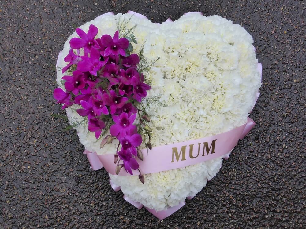 29. White Carnation Heart with cerise Dendrobium Orchids and ribbon sash
