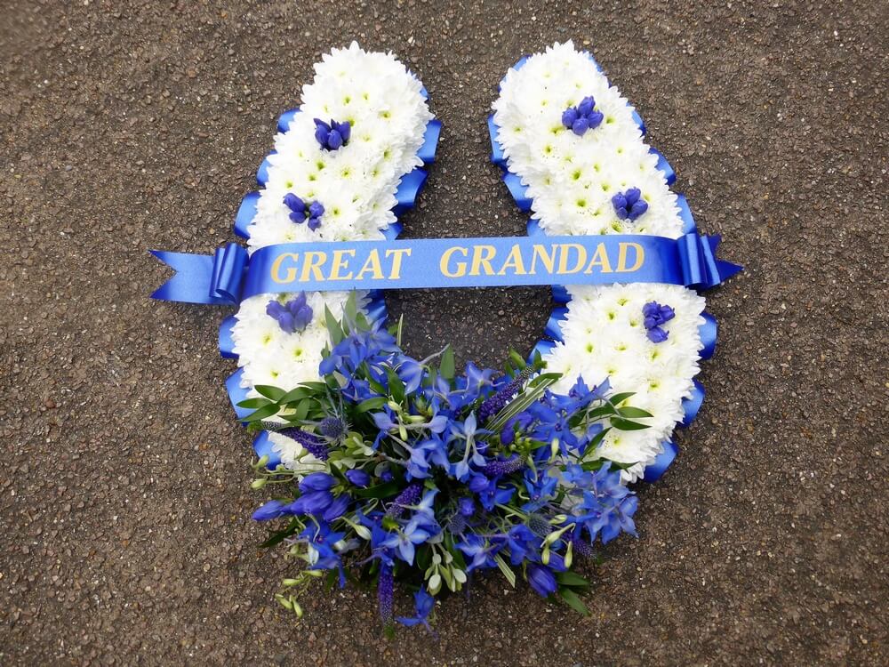 1. Large Horseshoe in blue and white with blue ribbon edge and sash. Delphinium and Gentiana posy