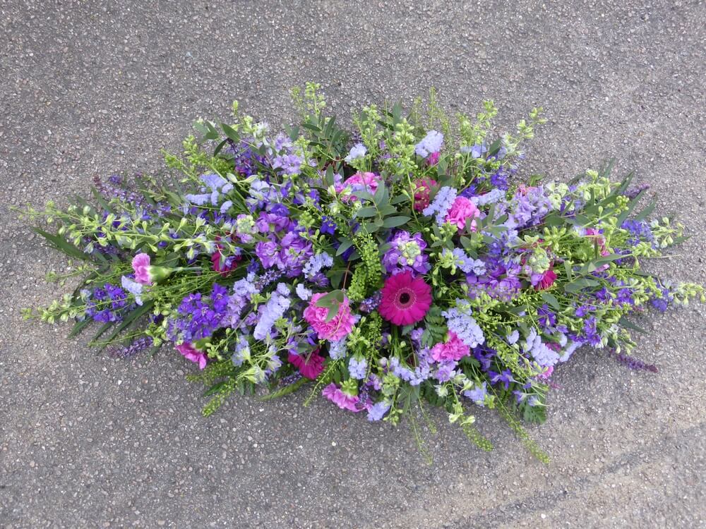 44. Loose spray in purples with Germini, Carnations, Larkspur, Stocks, Statice and Salvias