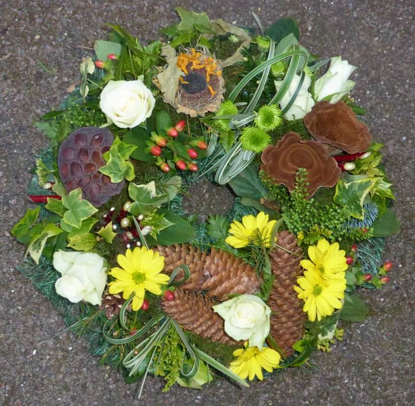 30.  12” Natural wreath with cones, berries, dried Sunflowers etc