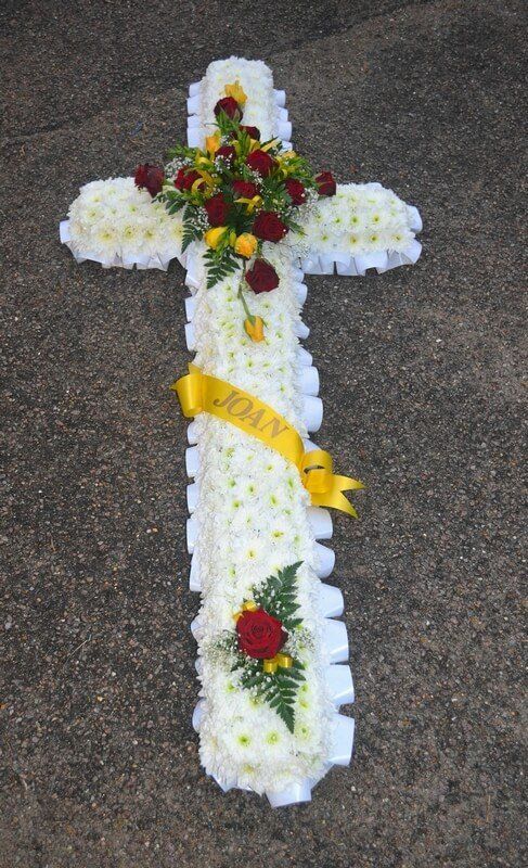 7. 5ft Cross with white ribbon edge, red and yellow Rose posies and ribbon sash